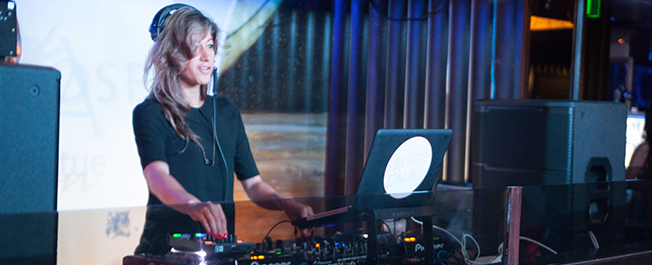 Female DJ performing live at musical event in NYC