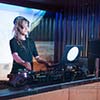 Female DJ performing live for crowd at event