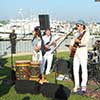 Band performing live at spacious outdoor event on the waterfront