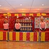 Performers standing with vintage fair ground carnival games as engaging novelty entertainment